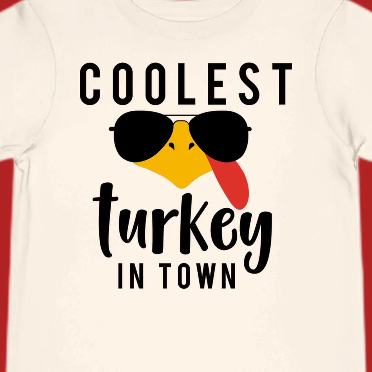 Coolest Turkey In Town Thanksgiving design with a cartoon turkey wearing sunglasses and sticking its tongue out.