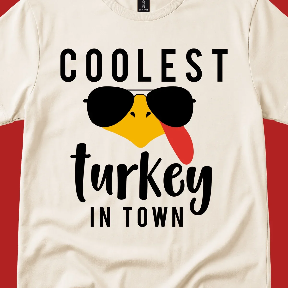 Coolest Turkey In Town Thanksgiving design with a cartoon turkey wearing sunglasses and sticking its tongue out.