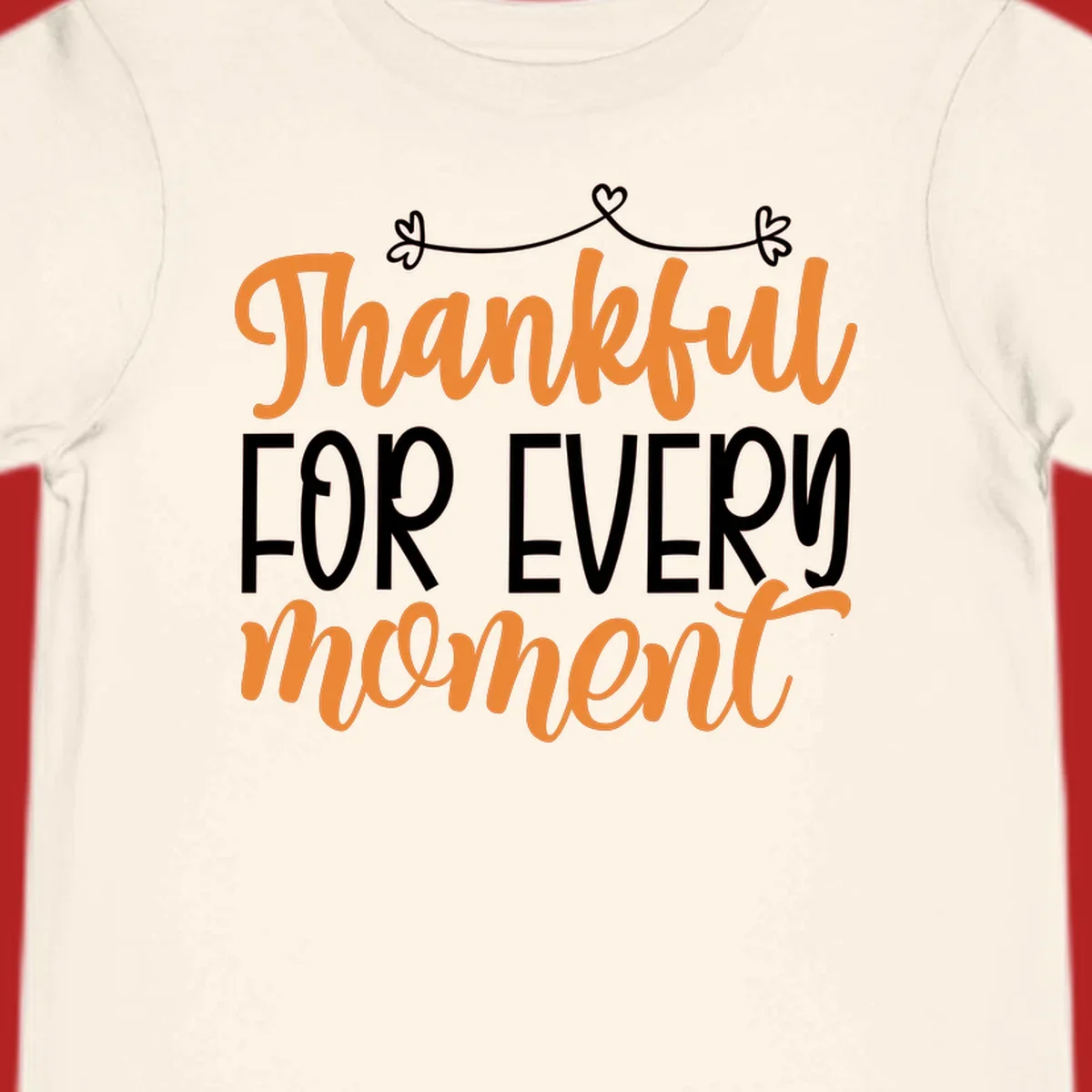 Thankful for every moment text design with orange and white lettering on black background.