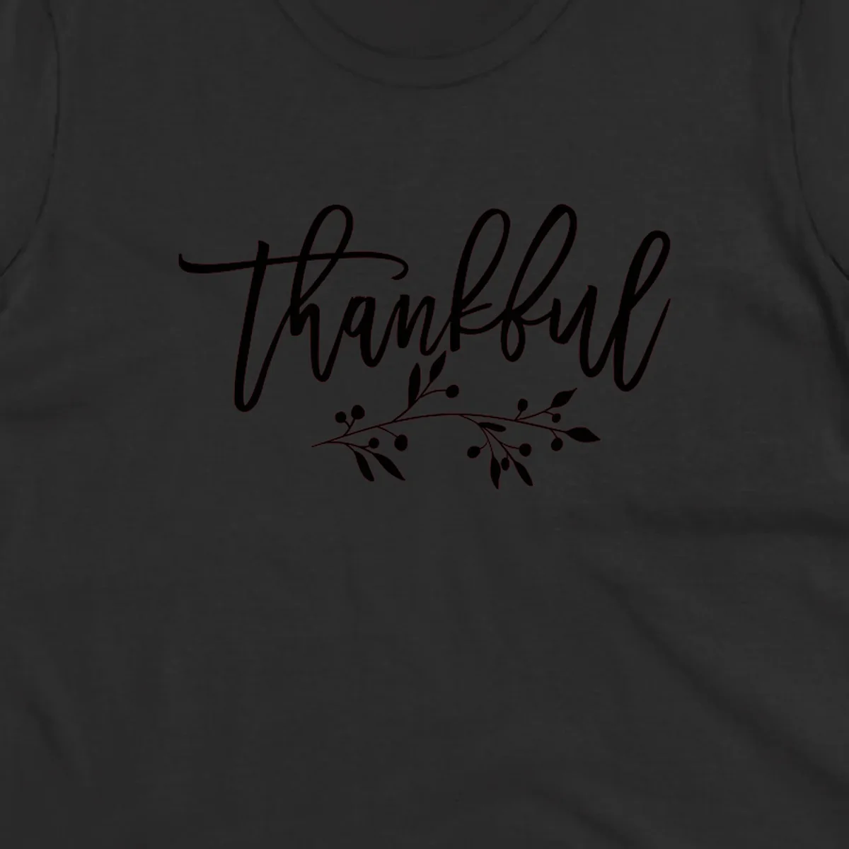 Elegant script text 'Thankful' with a small botanical branch accent, on a plain background.