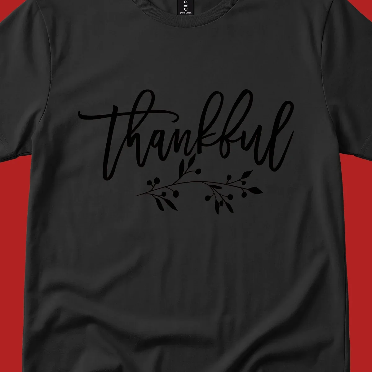 Elegant script text 'Thankful' with a small botanical branch accent, on a plain background.