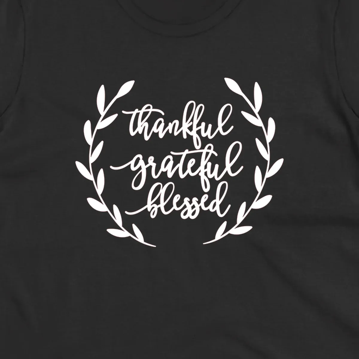 Thankful grateful blessed text inside a wreath graphic.