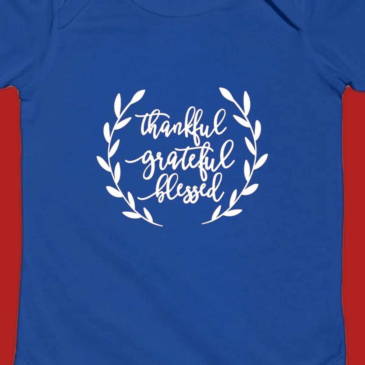Thankful grateful blessed text inside a wreath graphic.