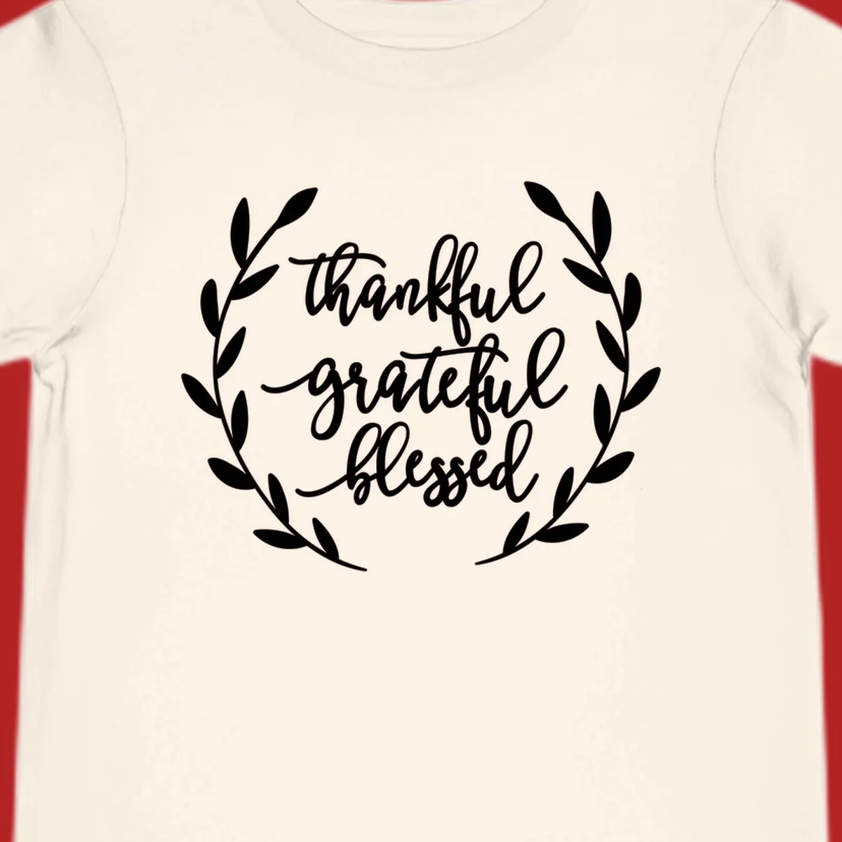 Thankful grateful blessed text inside a wreath graphic.