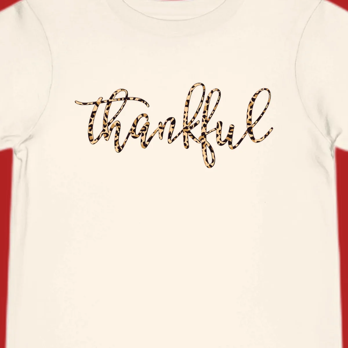 Thankful text in leopard print with a white outline.