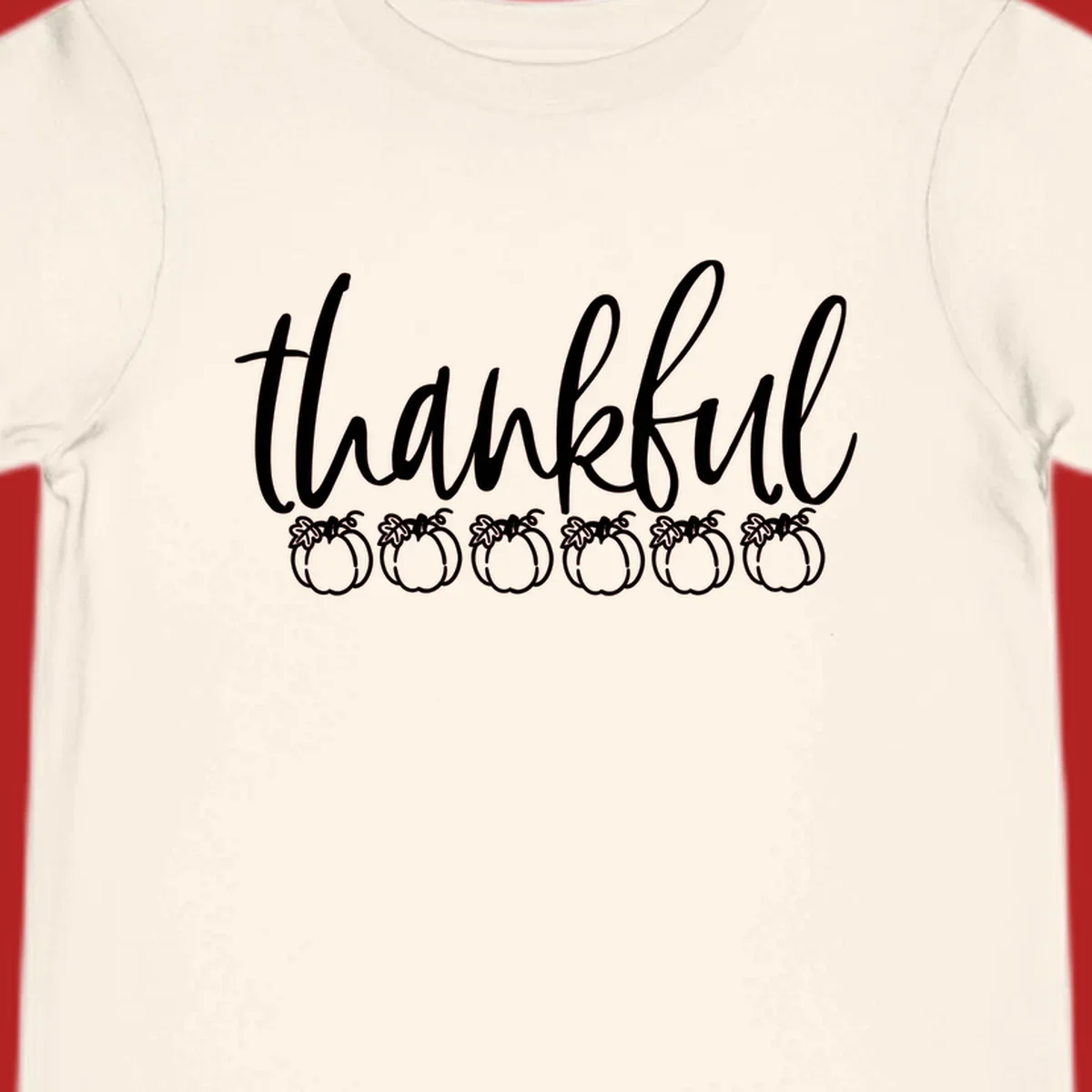 White script text 'thankful' above six white pumpkin illustrations, thankful pumpkins thanksgiving