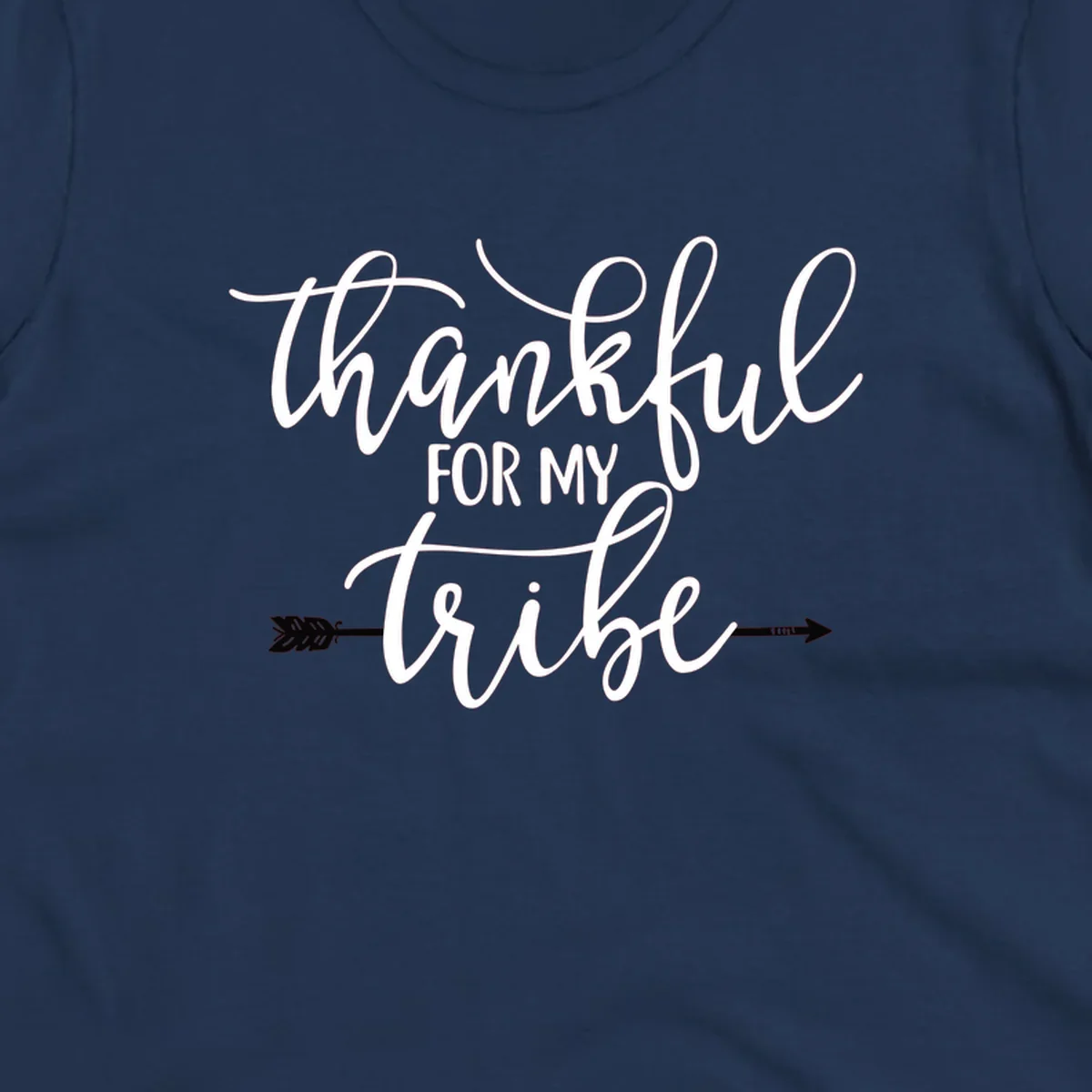 Thankful for my tribe typography design with arrow graphic on black background.