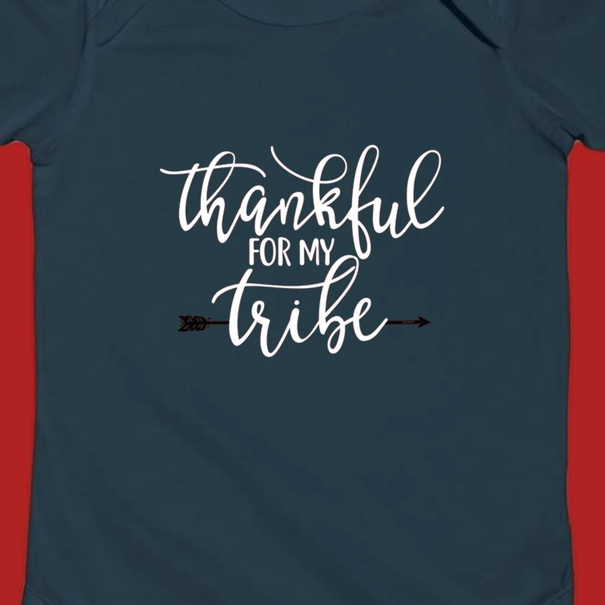 Thankful for my tribe typography design with arrow graphic on black background.