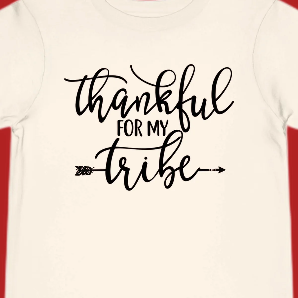 Thankful for my tribe typography design with arrow graphic on black background.