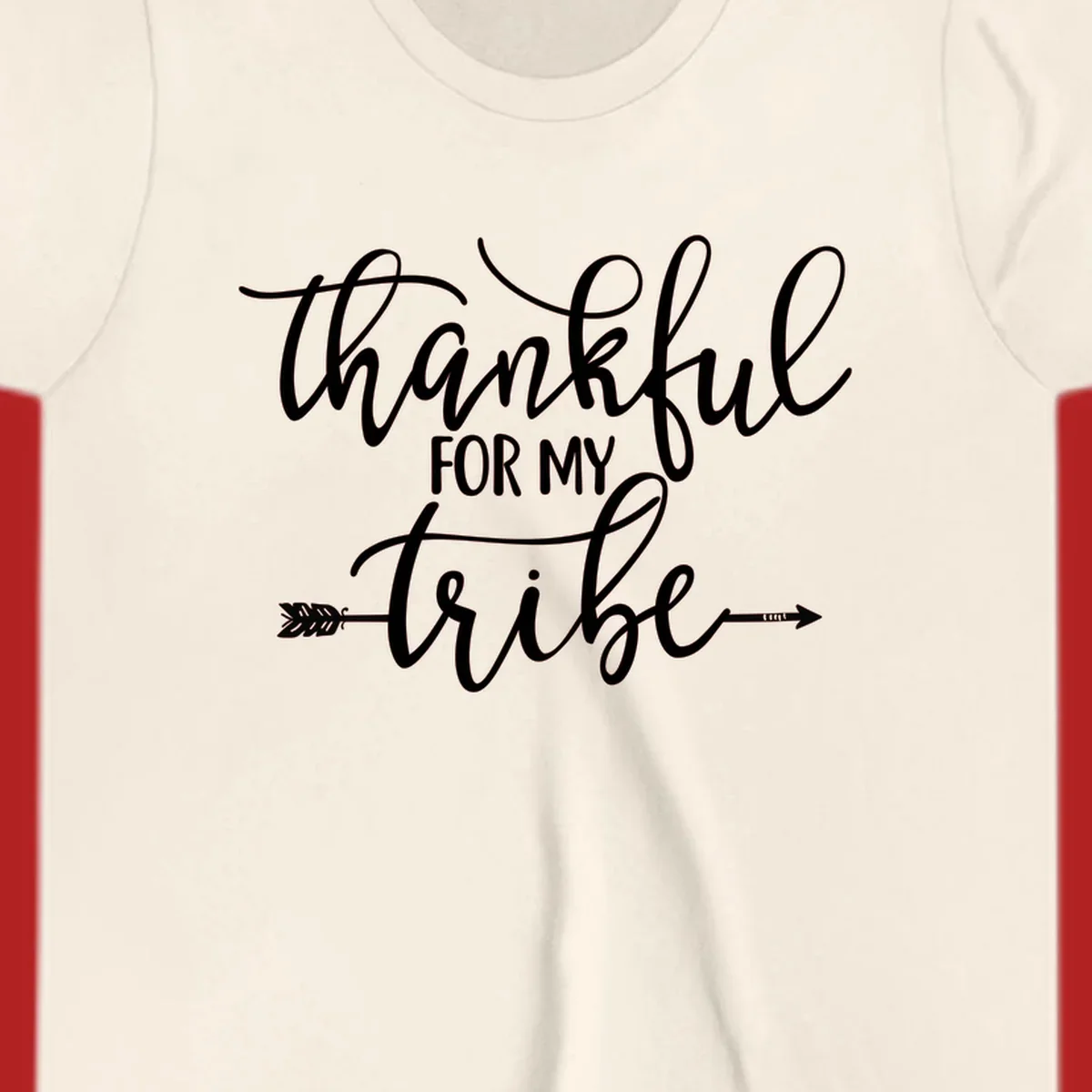 Thankful for my tribe typography design with arrow graphic on black background.