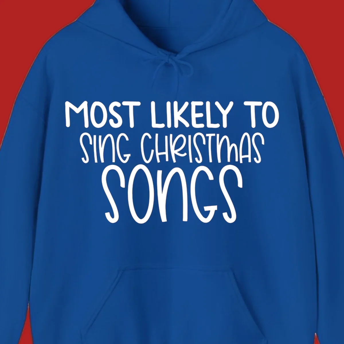 Text design 'Most Likely To Sing Christmas Songs' in white, bold lettering.