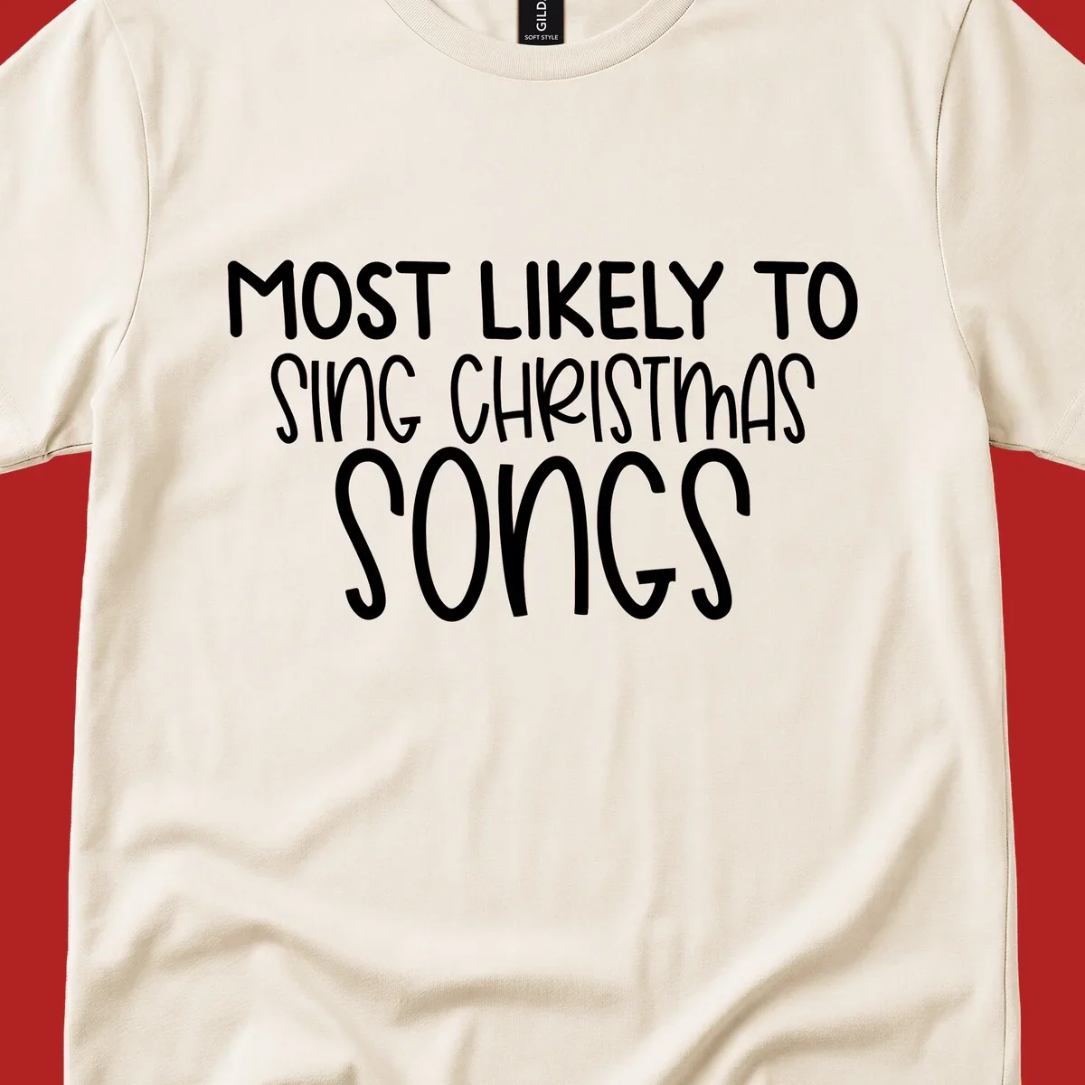 Text design 'Most Likely To Sing Christmas Songs' in white, bold lettering.