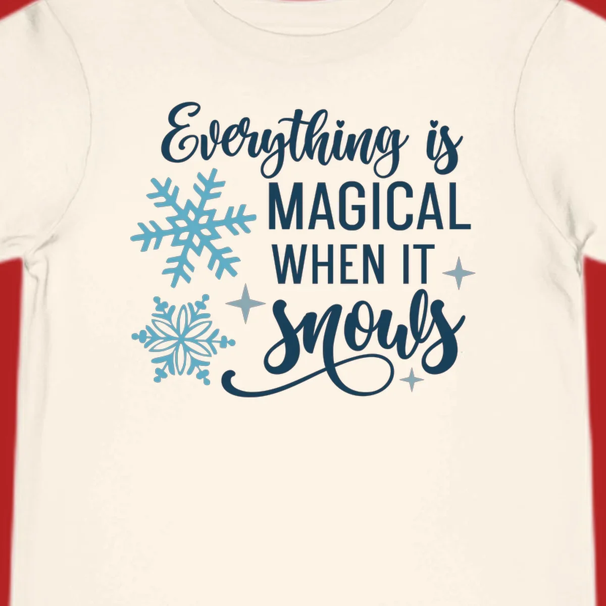 Everything is Magical When It Snows typography with snowflakes and stars.
