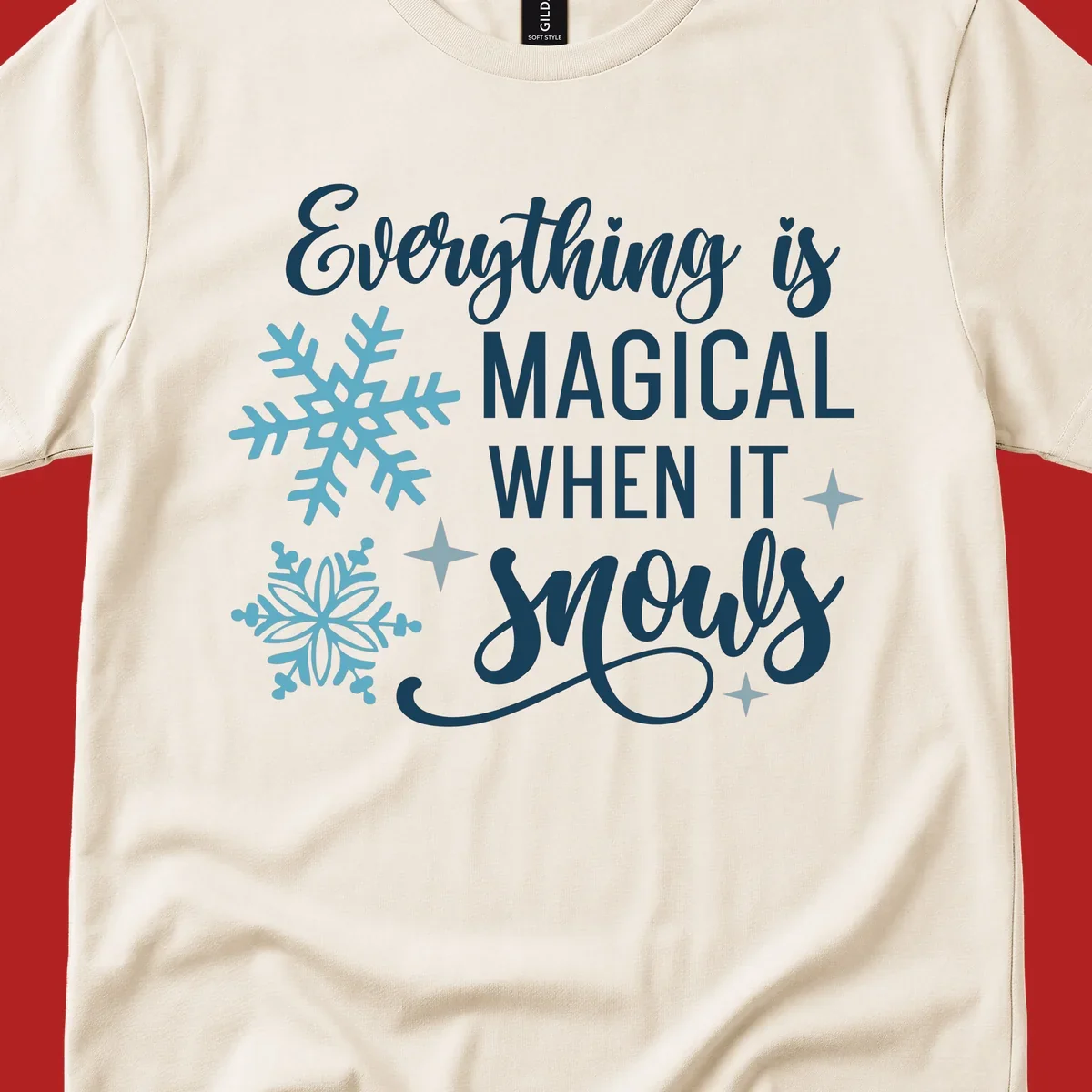 Everything is Magical When It Snows typography with snowflakes and stars.