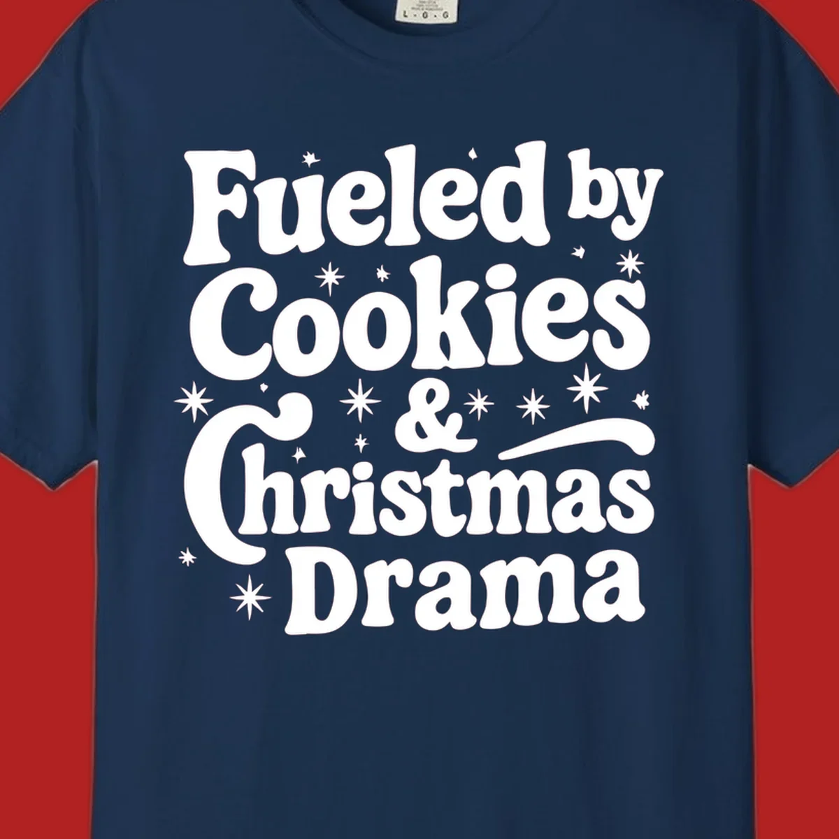 Text design 'Fueled by Cookies & Christmas Drama' with stars, for Christmas.