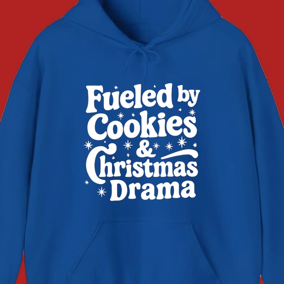 Text design 'Fueled by Cookies & Christmas Drama' with stars, for Christmas.