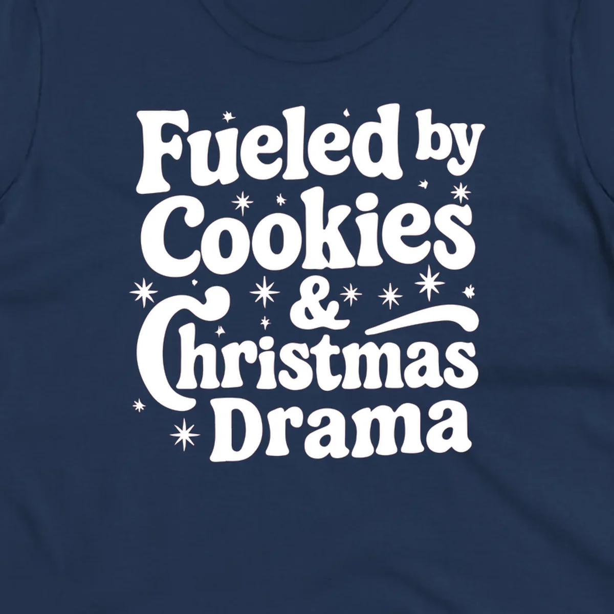 Text design 'Fueled by Cookies & Christmas Drama' with stars, for Christmas.