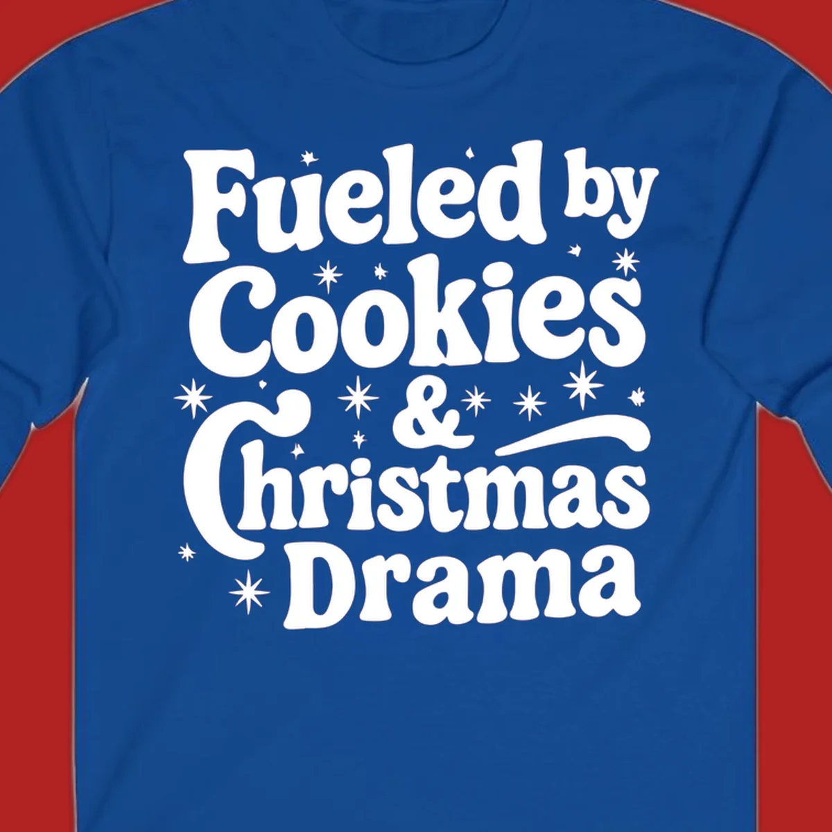 Text design 'Fueled by Cookies & Christmas Drama' with stars, for Christmas.