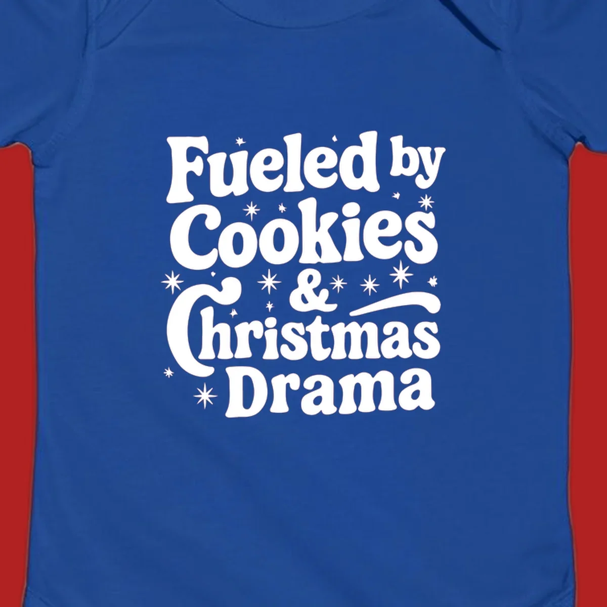 Text design 'Fueled by Cookies & Christmas Drama' with stars, for Christmas.