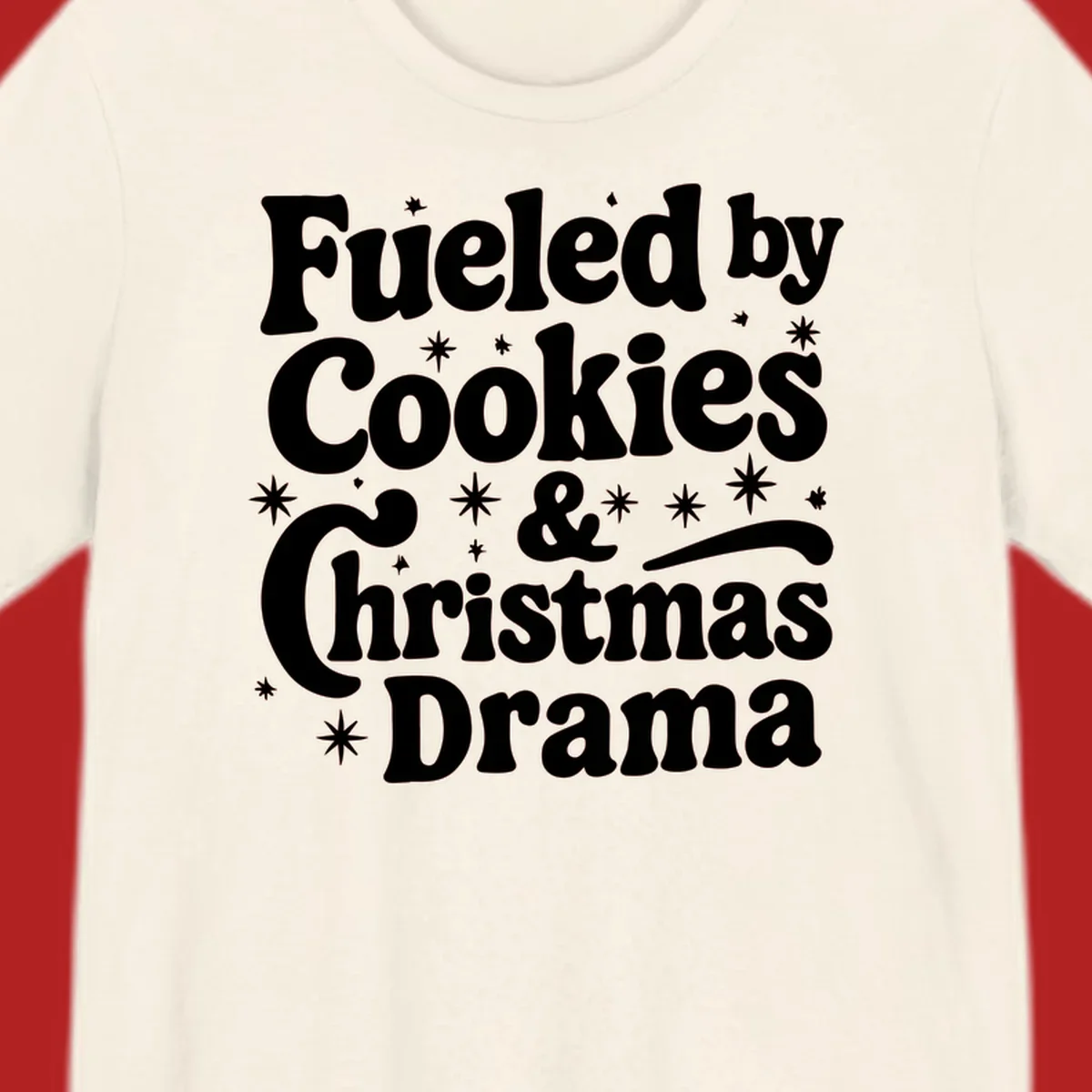 Text design 'Fueled by Cookies & Christmas Drama' with stars, for Christmas.