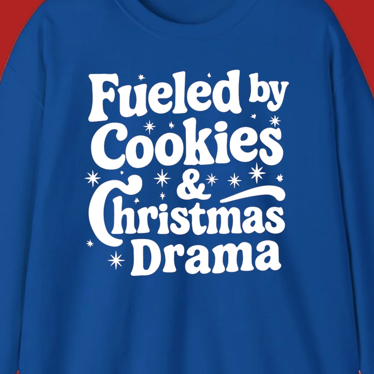 Text design 'Fueled by Cookies & Christmas Drama' with stars, for Christmas.