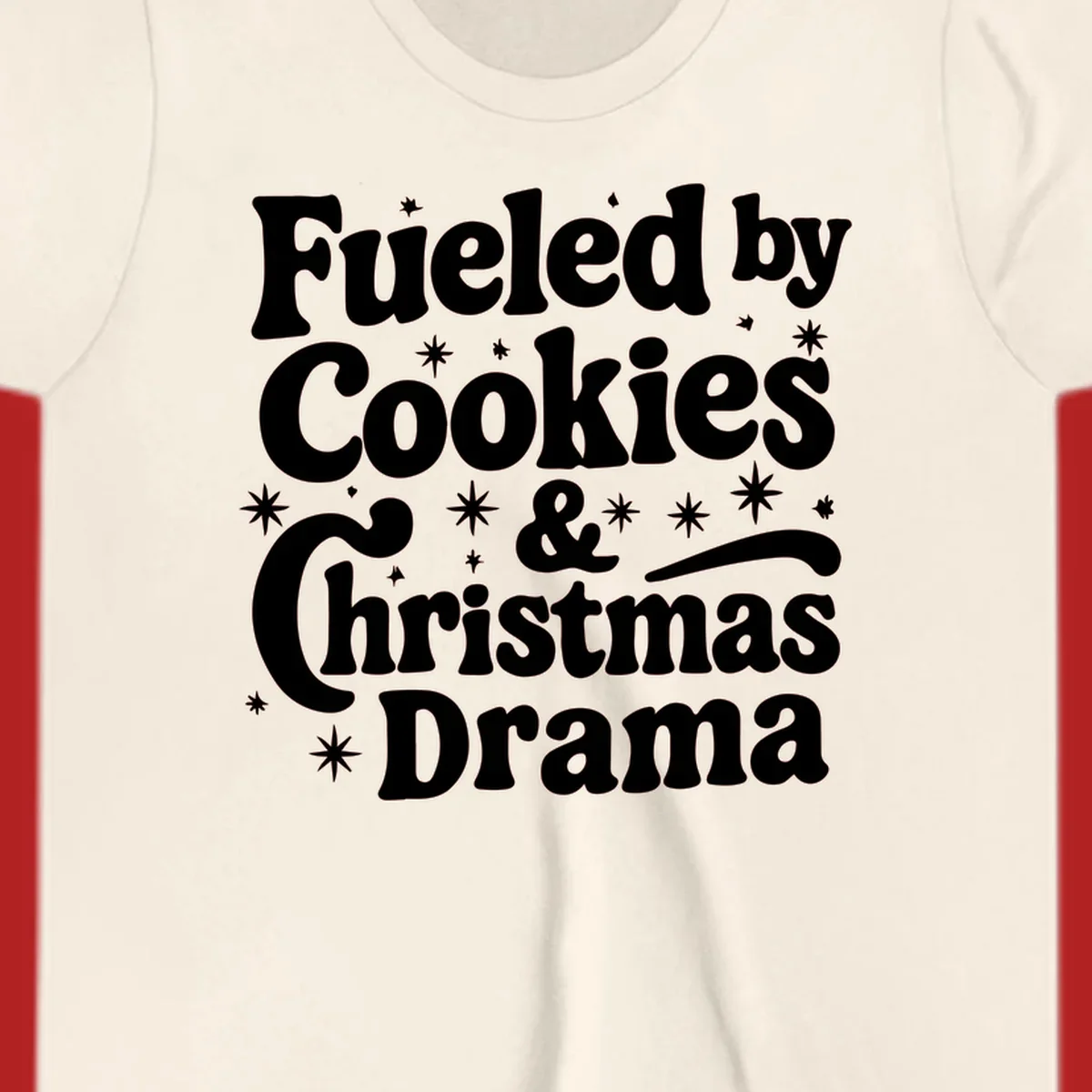 Text design 'Fueled by Cookies & Christmas Drama' with stars, for Christmas.
