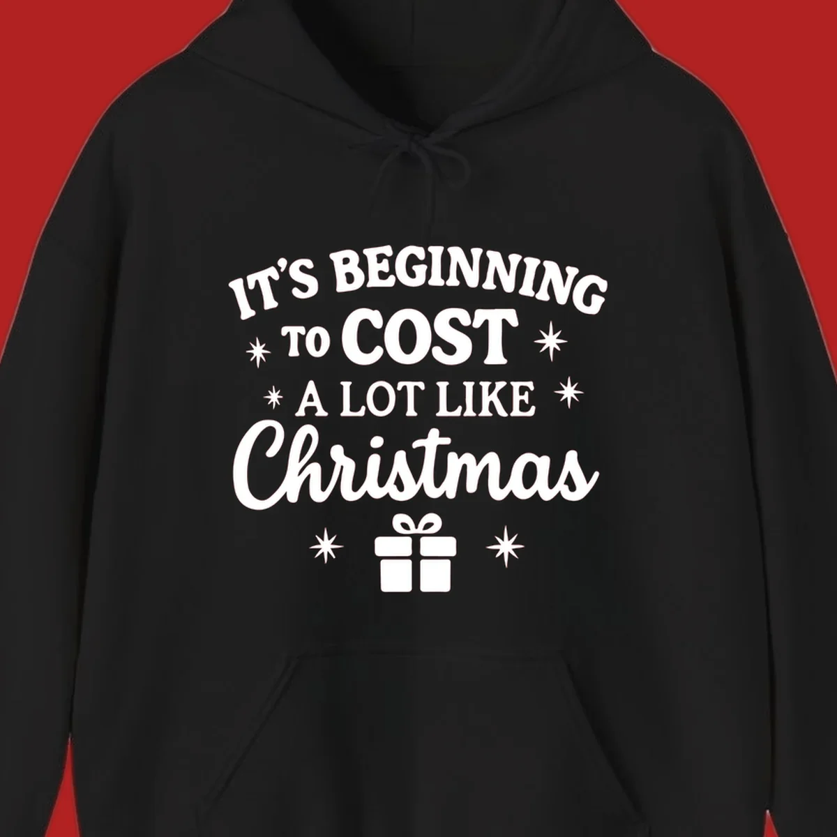 Typography design that says "It's Beginning To Cost A Lot Like Christmas" with stars and a gift box.