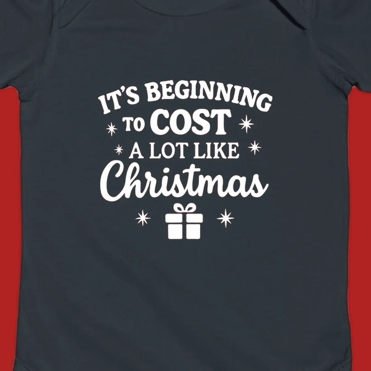Typography design that says "It's Beginning To Cost A Lot Like Christmas" with stars and a gift box.