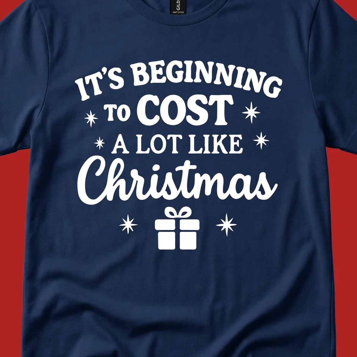 Typography design that says "It's Beginning To Cost A Lot Like Christmas" with stars and a gift box.
