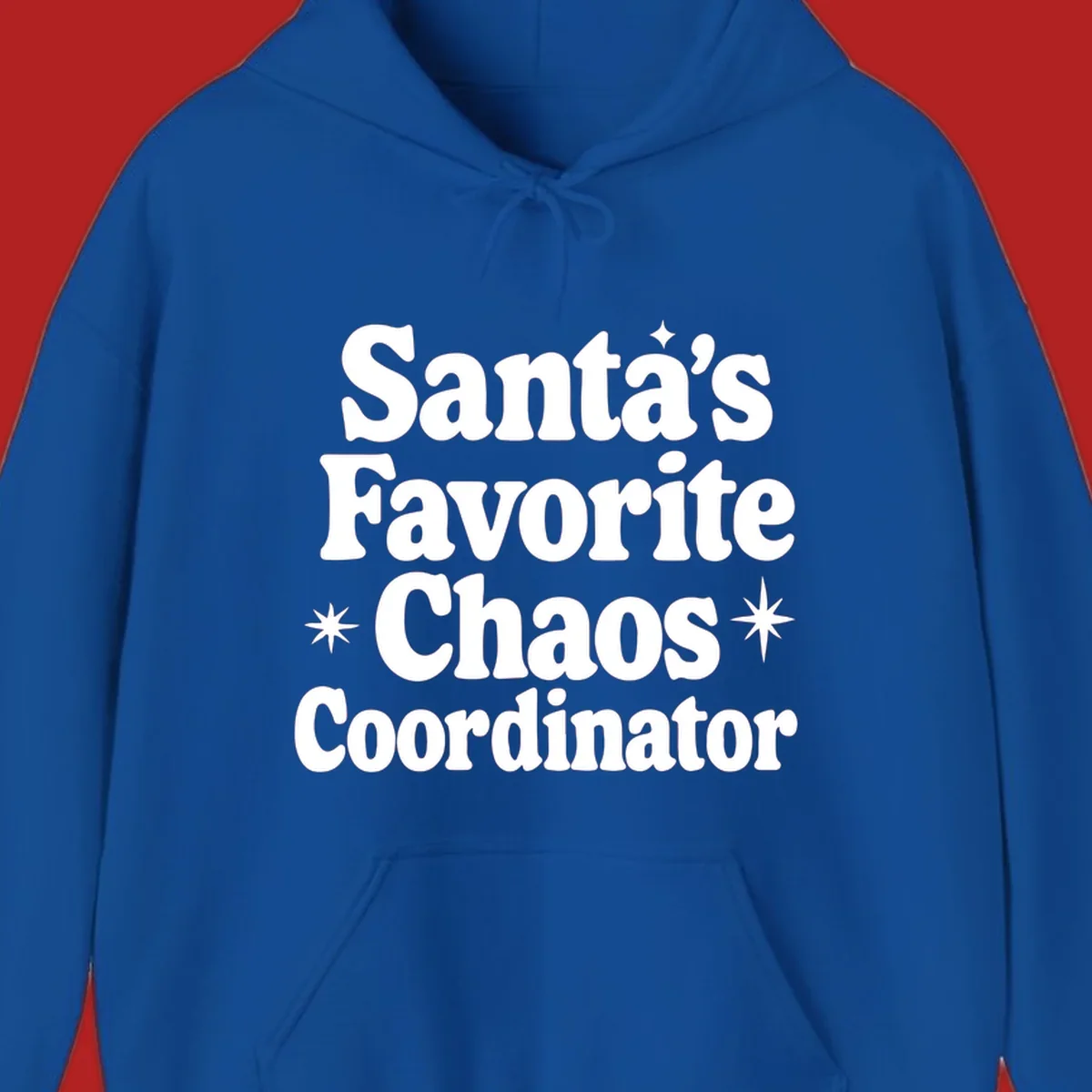 White retro typography reads 'Santa's Favorite Chaos Coordinator' with star accents.