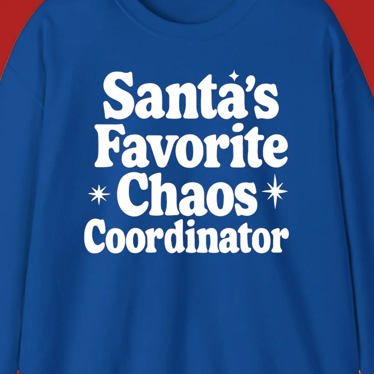 White retro typography reads 'Santa's Favorite Chaos Coordinator' with star accents.