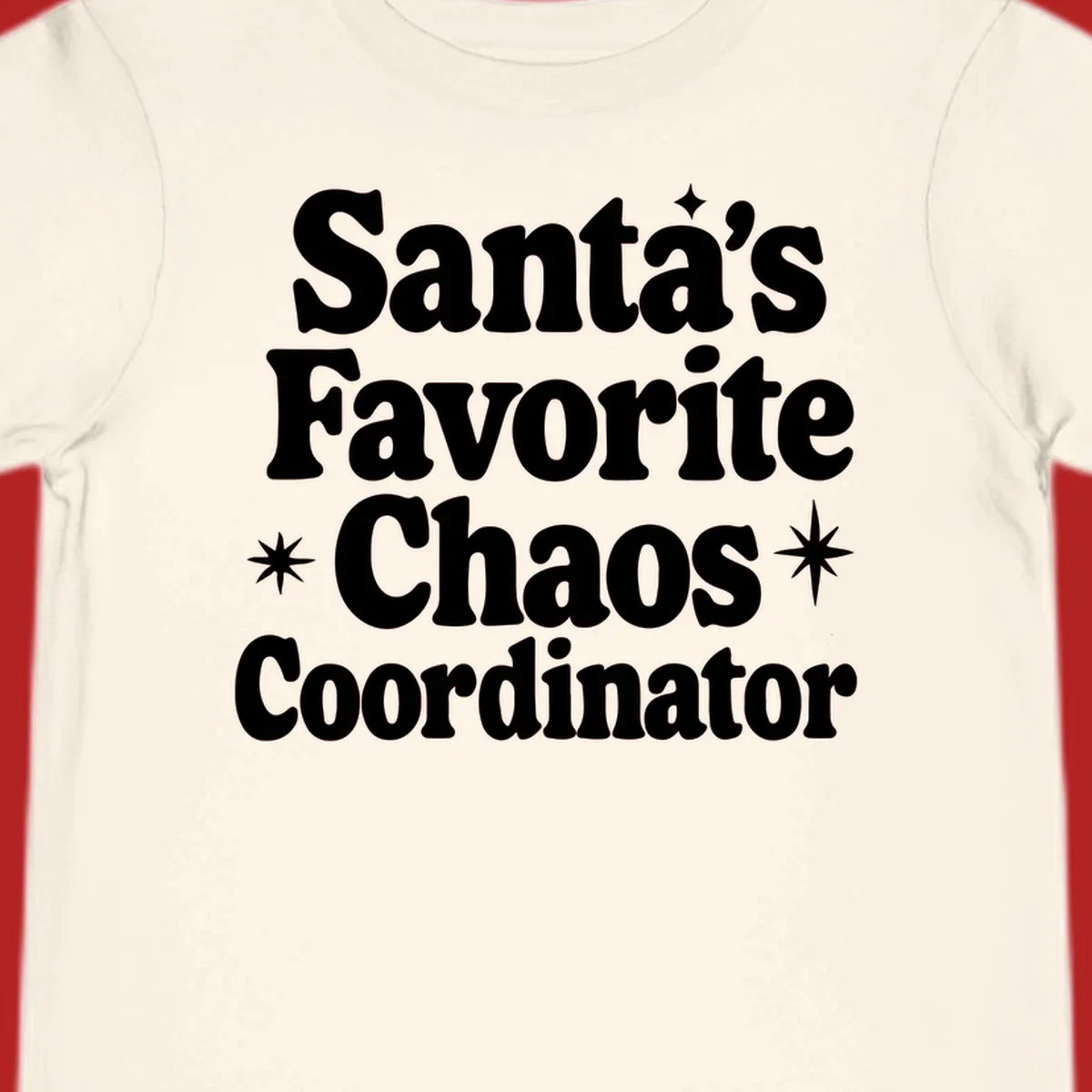 White retro typography reads 'Santa's Favorite Chaos Coordinator' with star accents.