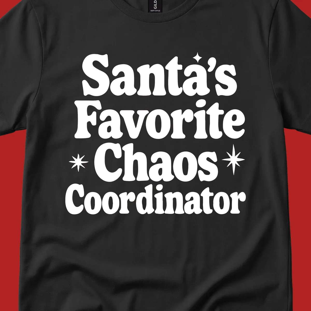White retro typography reads 'Santa's Favorite Chaos Coordinator' with star accents.