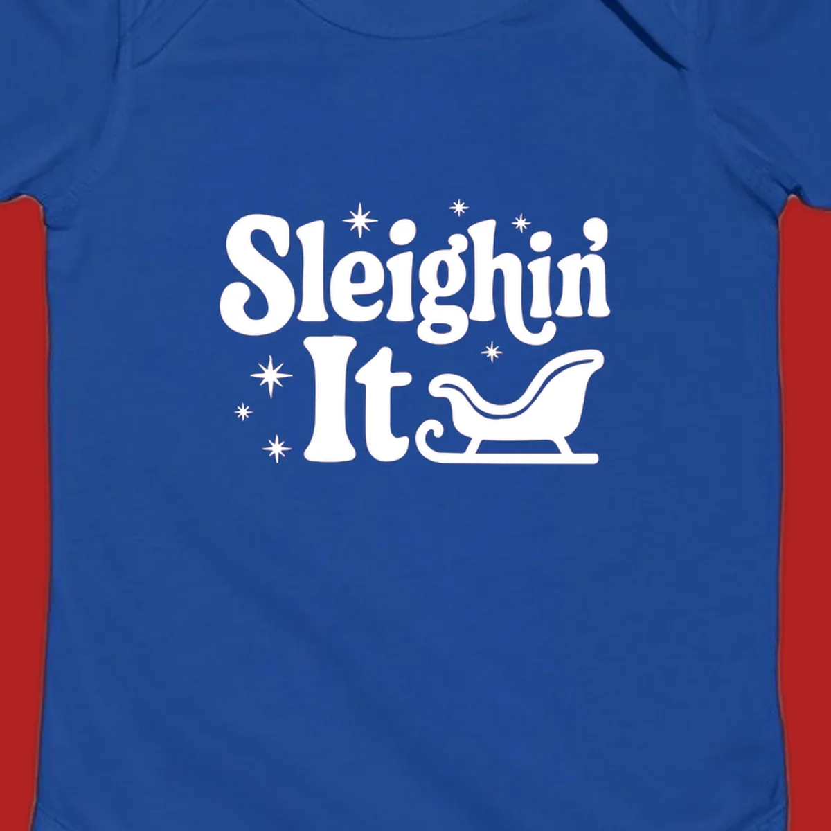 Sleighin It Christmas text and sleigh graphic.