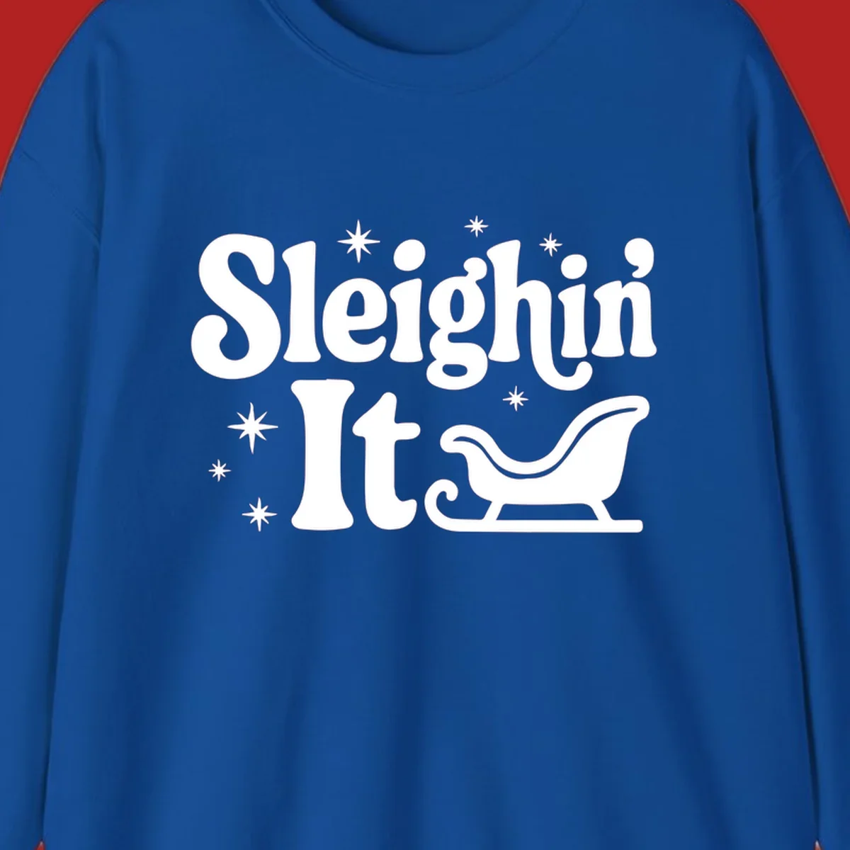Sleighin It Christmas text and sleigh graphic.