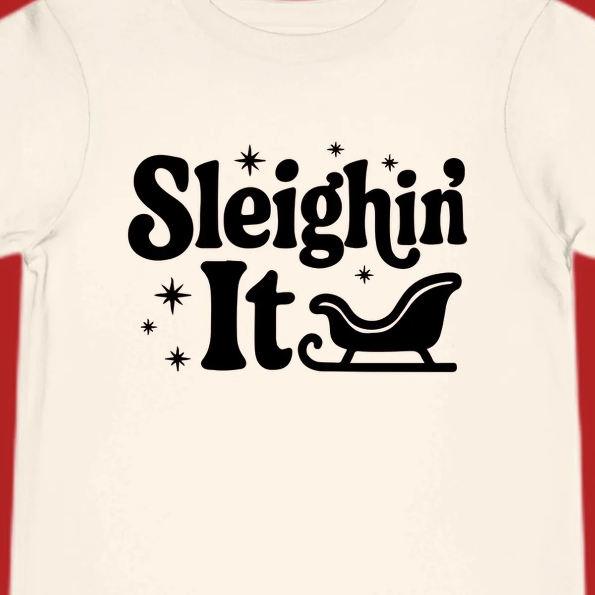 Sleighin It Christmas text and sleigh graphic.