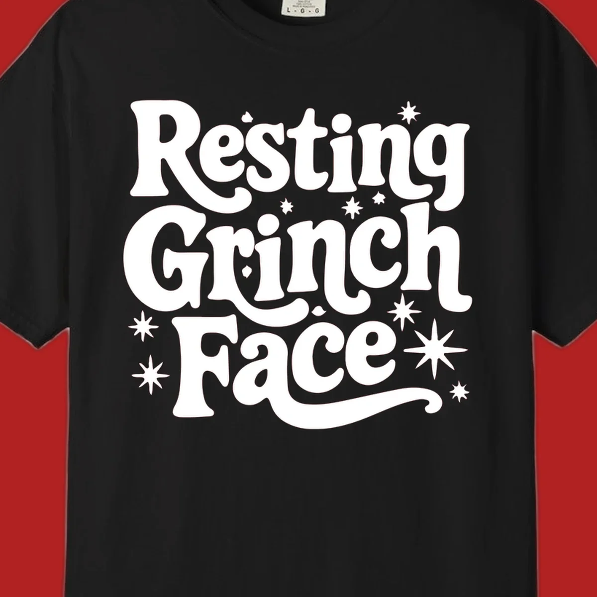 Resting Grinch Face text with stars, holiday design.