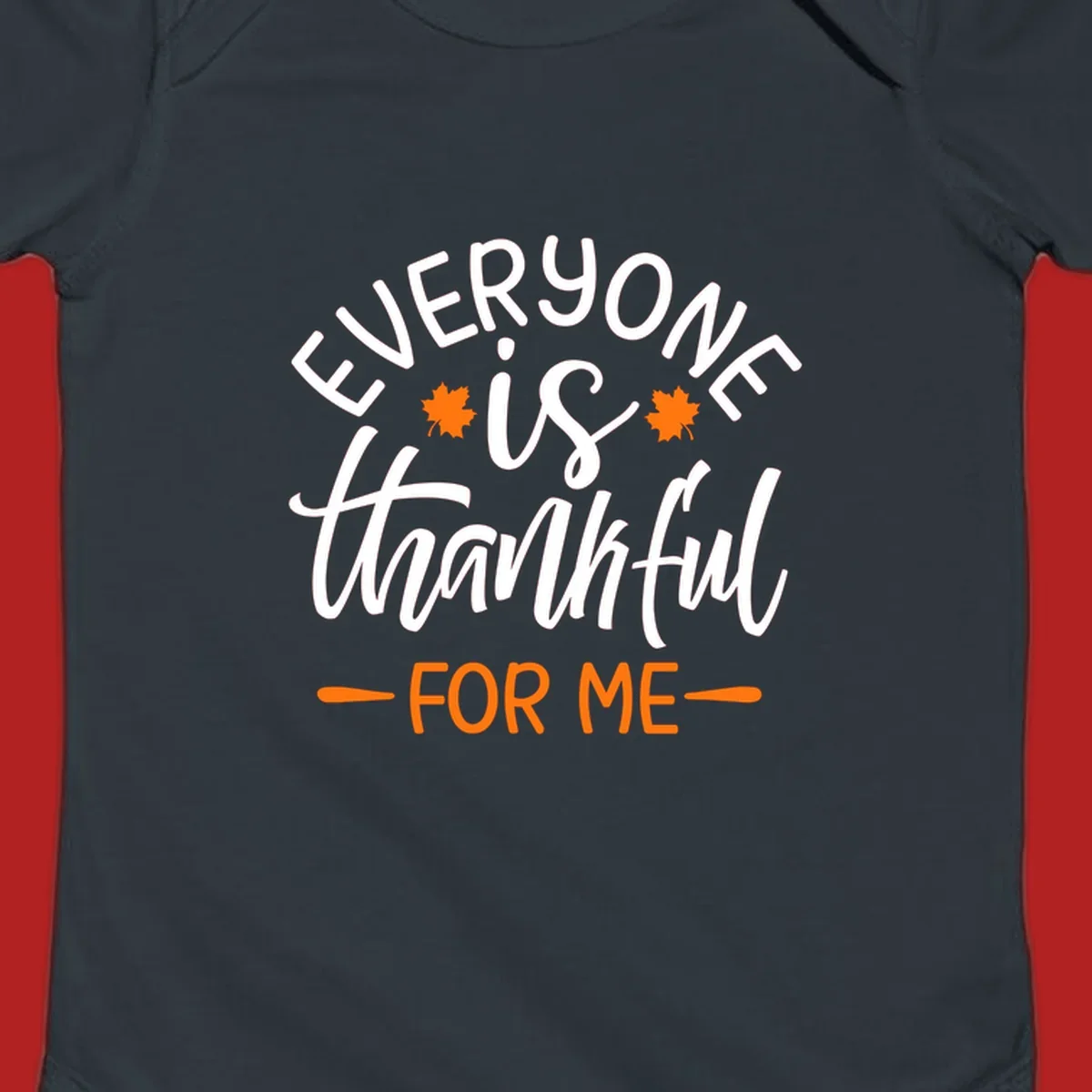 Typography design with text "EVERYONE is thankful FOR ME" and maple leaves, for Thanksgiving.