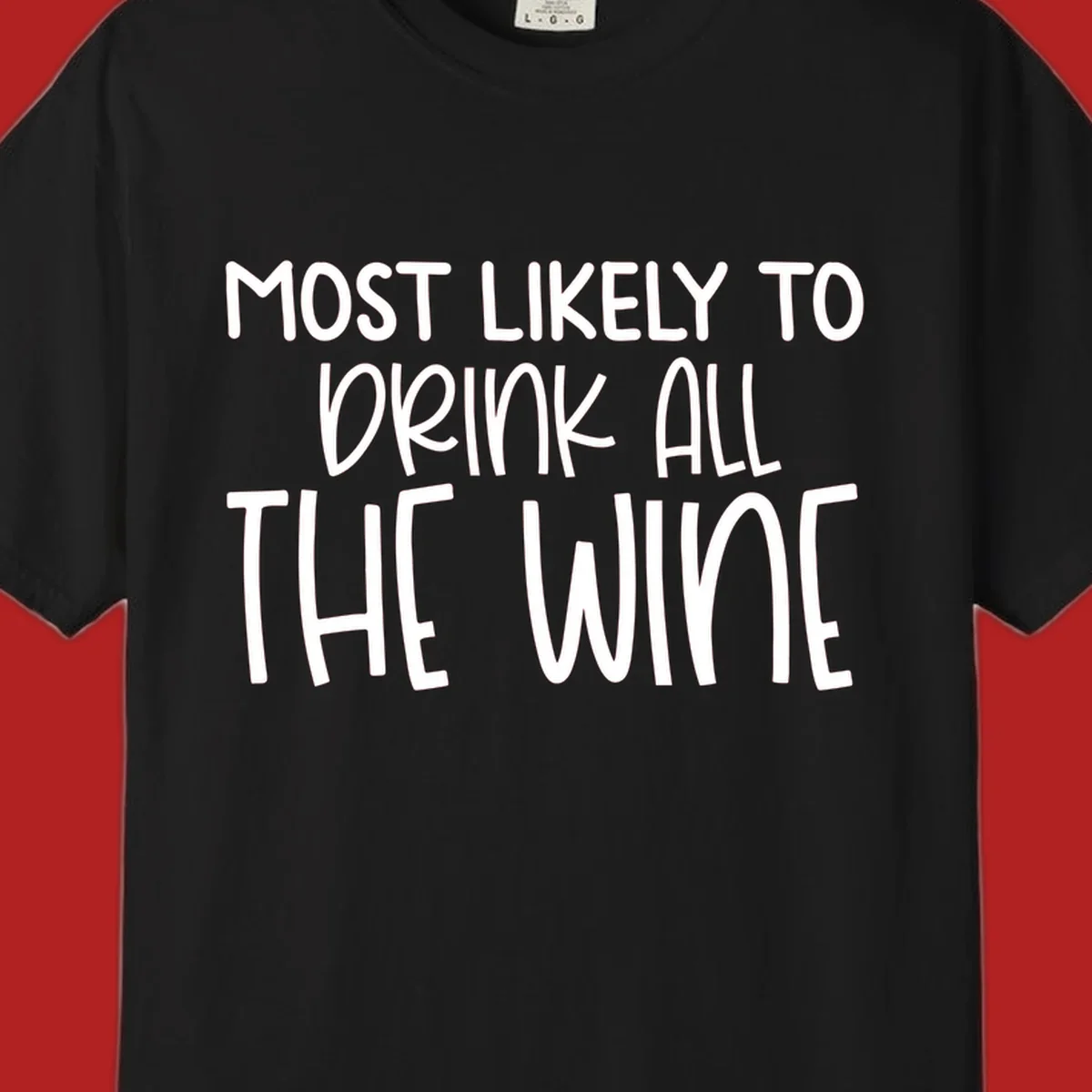Text design 'MOST LIKELY TO DRINK ALL THE WINE' in white lettering.