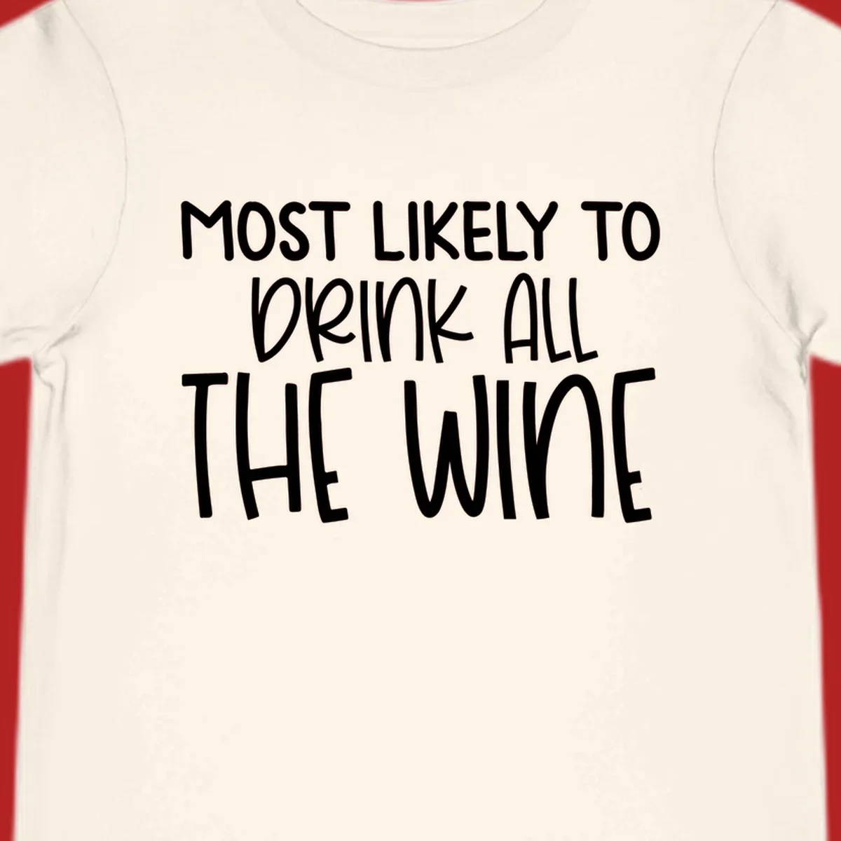 Text design 'MOST LIKELY TO DRINK ALL THE WINE' in white lettering.