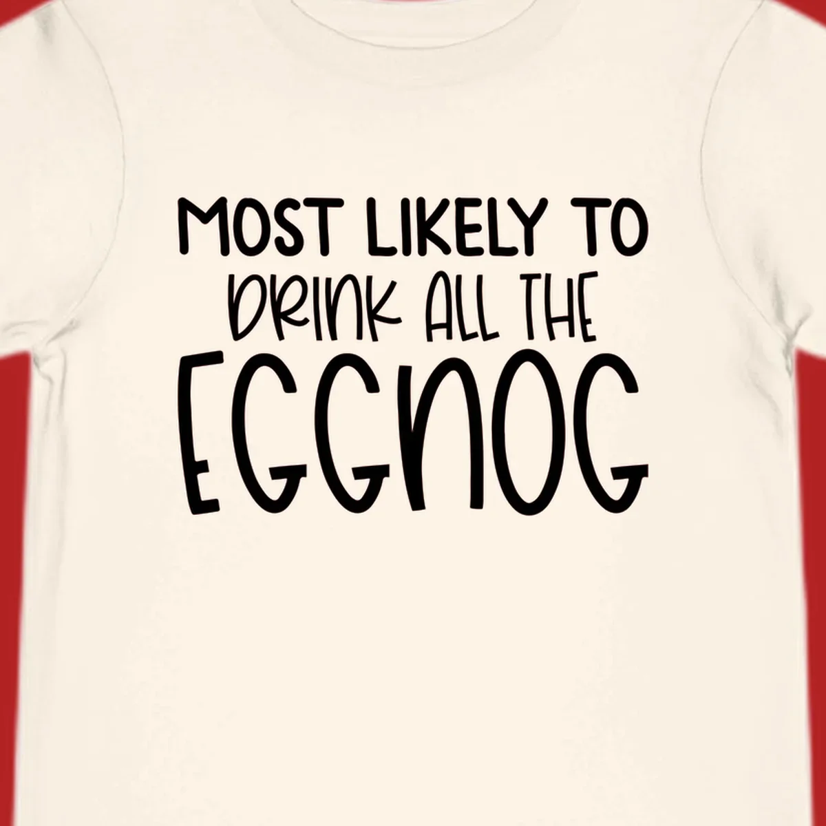 Text design 'Most Likely To Drink All The Eggnog' in white festive lettering for Christmas.
