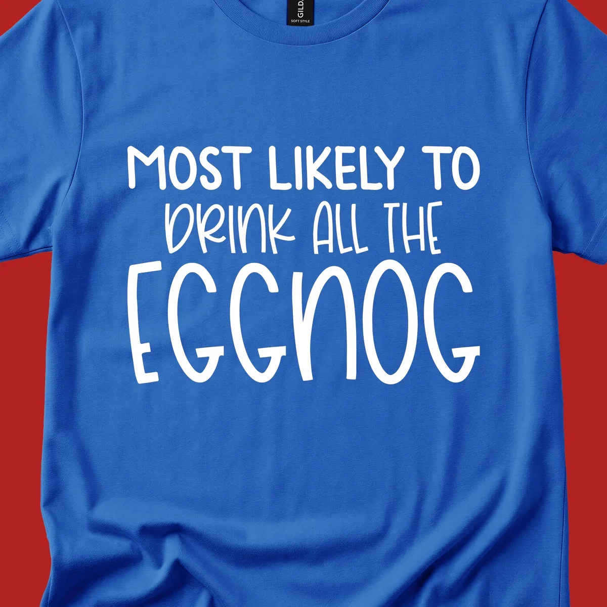 Text design 'Most Likely To Drink All The Eggnog' in white festive lettering for Christmas.