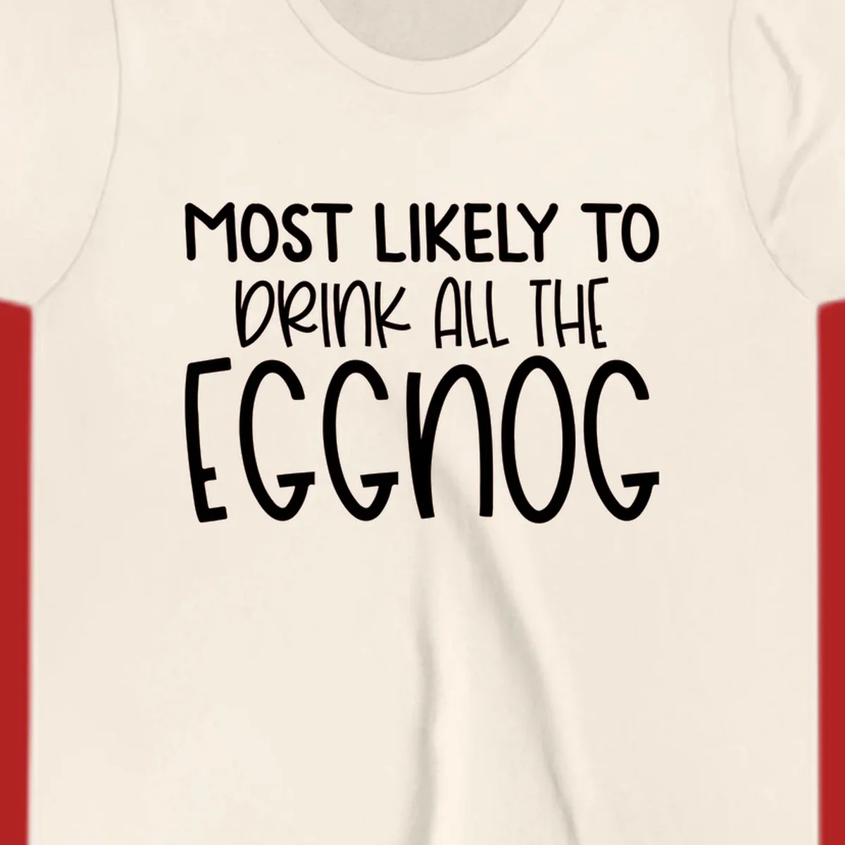 Text design 'Most Likely To Drink All The Eggnog' in white festive lettering for Christmas.