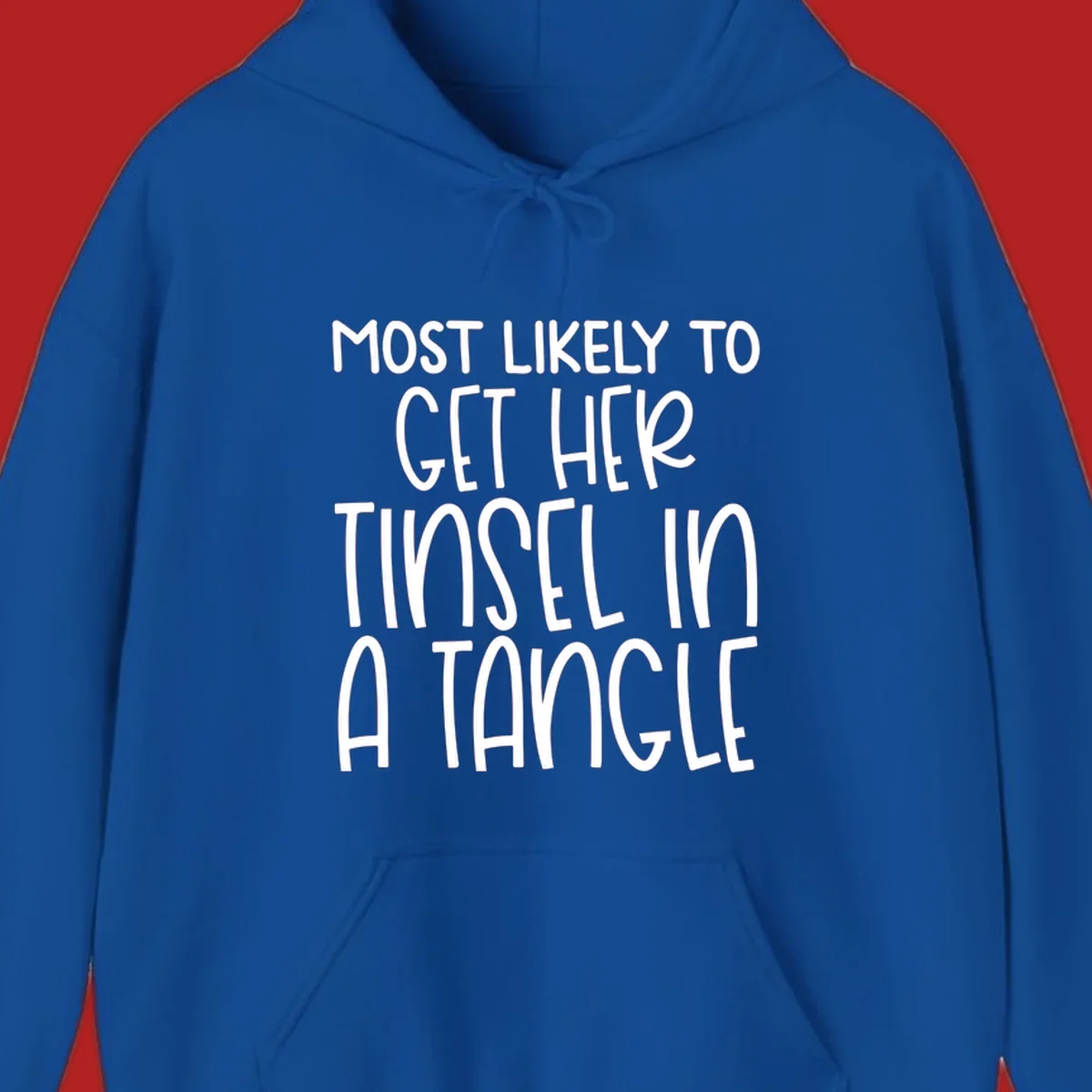 White text 'Most Likely To Get Her Tinsel In A Tangle' on a black background, holiday phrase.