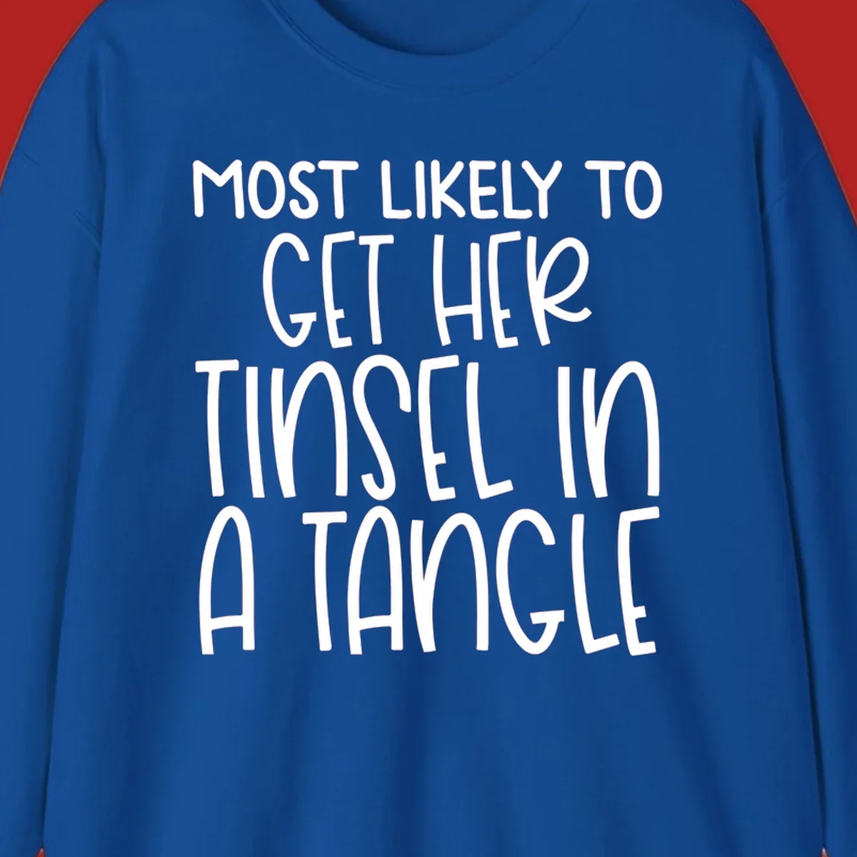 White text 'Most Likely To Get Her Tinsel In A Tangle' on a black background, holiday phrase.