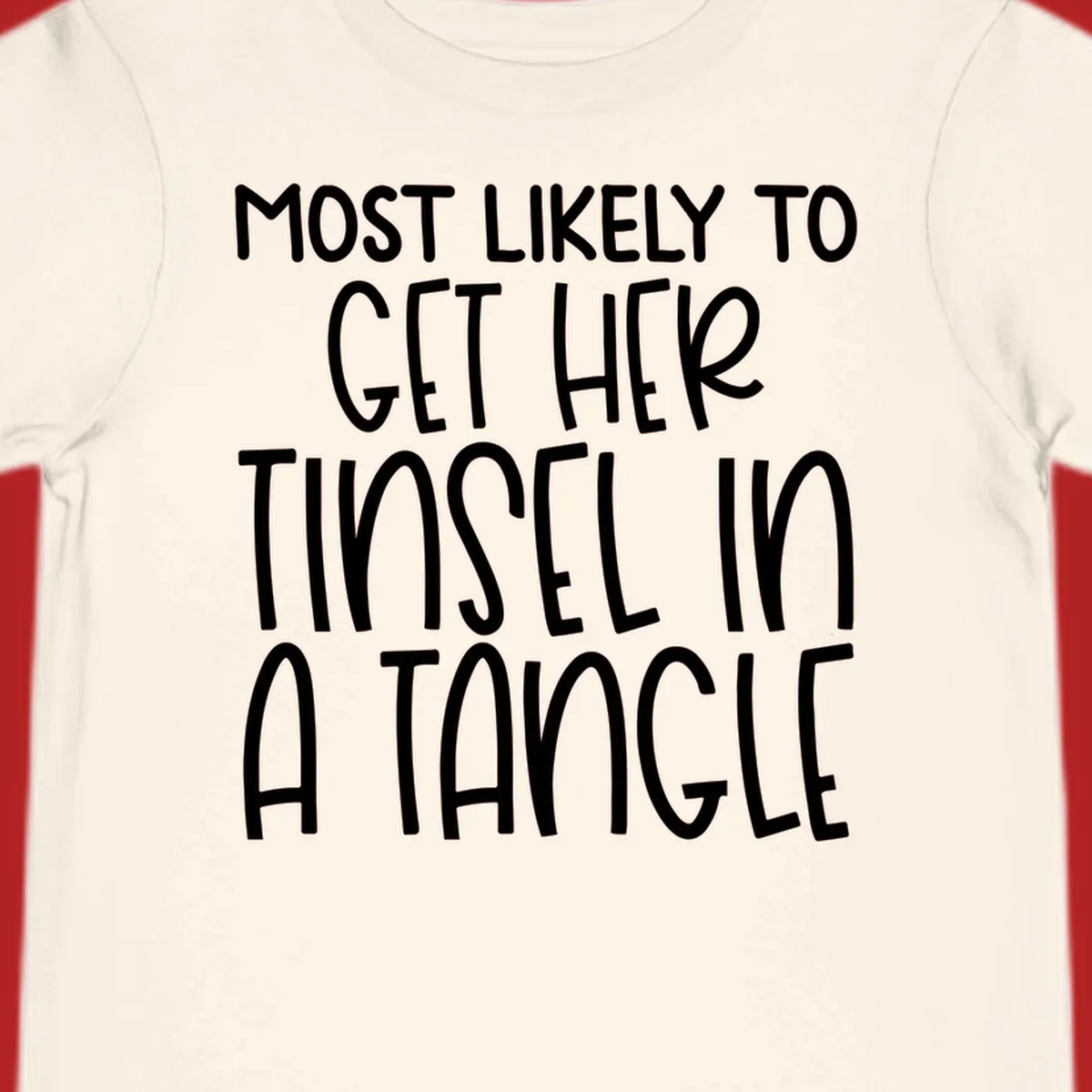White text 'Most Likely To Get Her Tinsel In A Tangle' on a black background, holiday phrase.