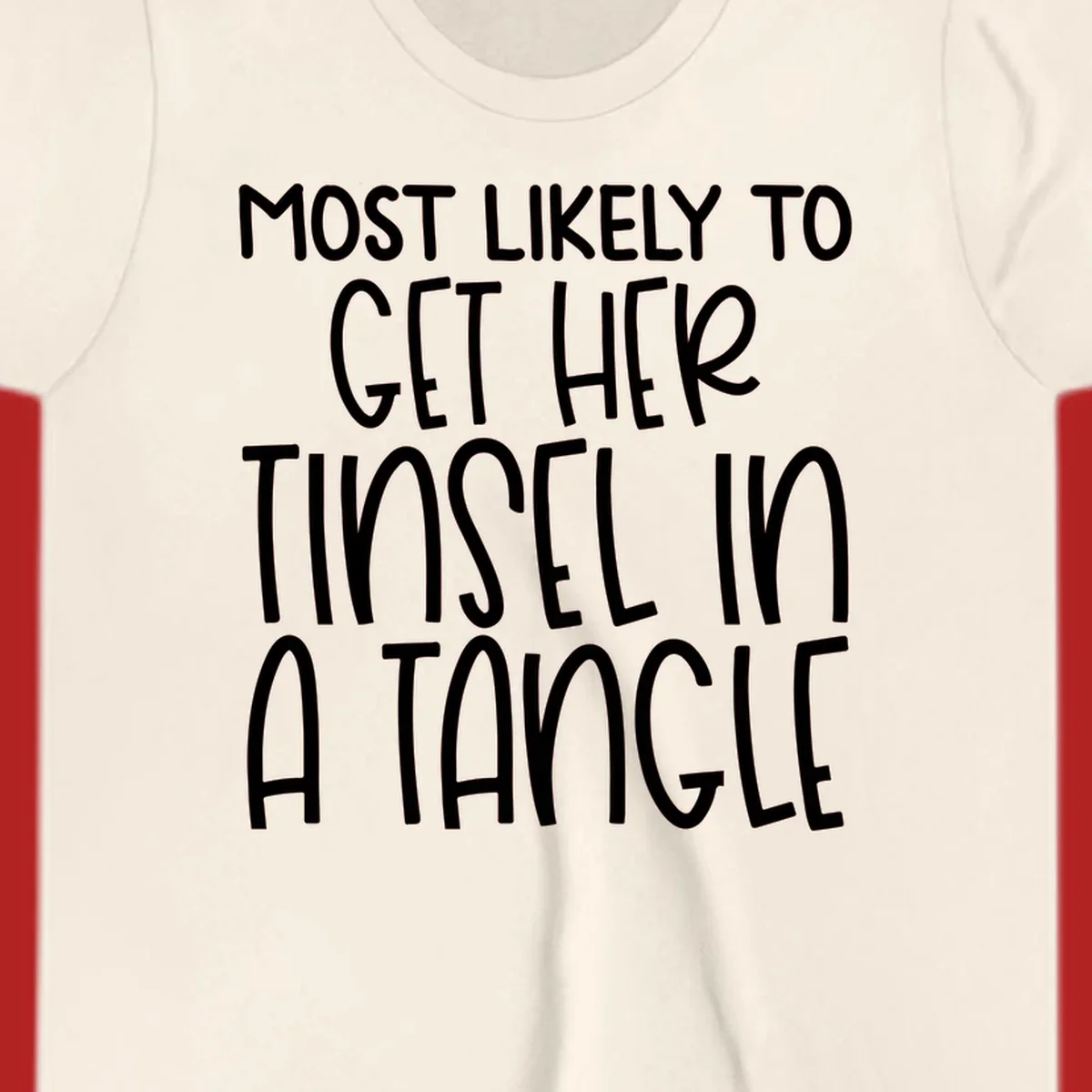 White text 'Most Likely To Get Her Tinsel In A Tangle' on a black background, holiday phrase.