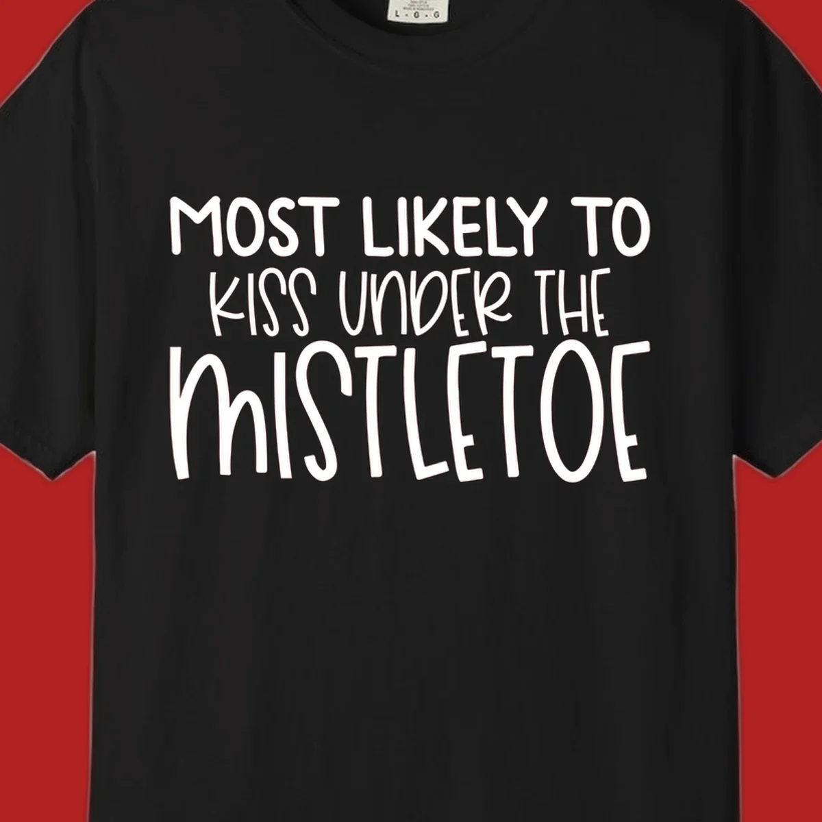 Typography design with the phrase 'Most Likely To Kiss Under Mistletoe' in white.
