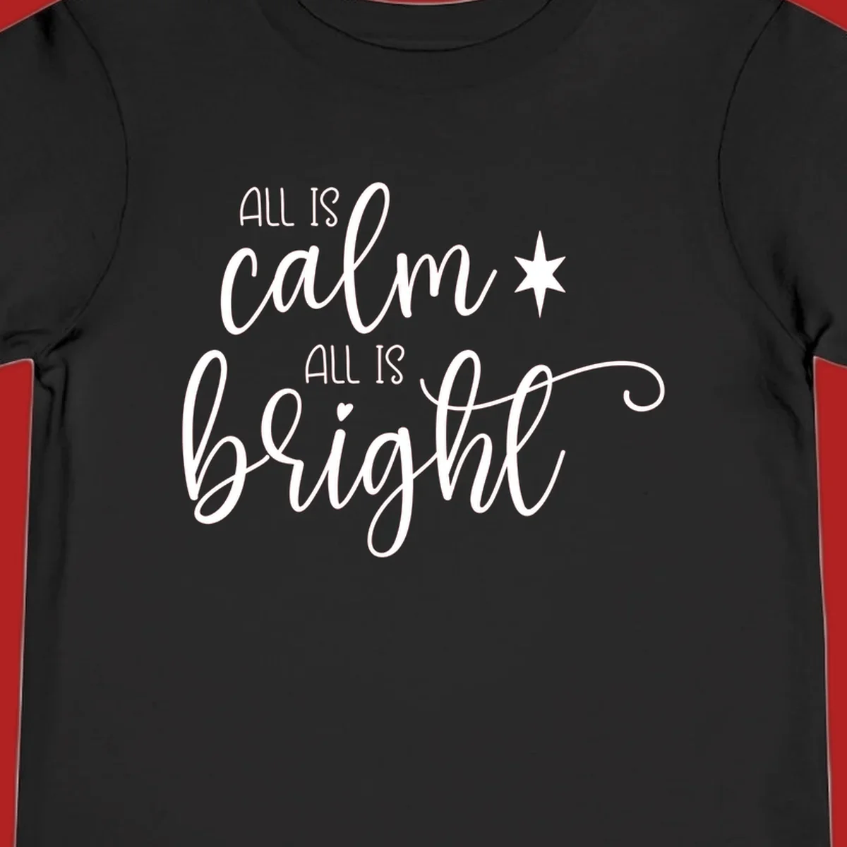 Elegant white script text 'All Is Calm All Is Bright' with star and heart, holiday design.