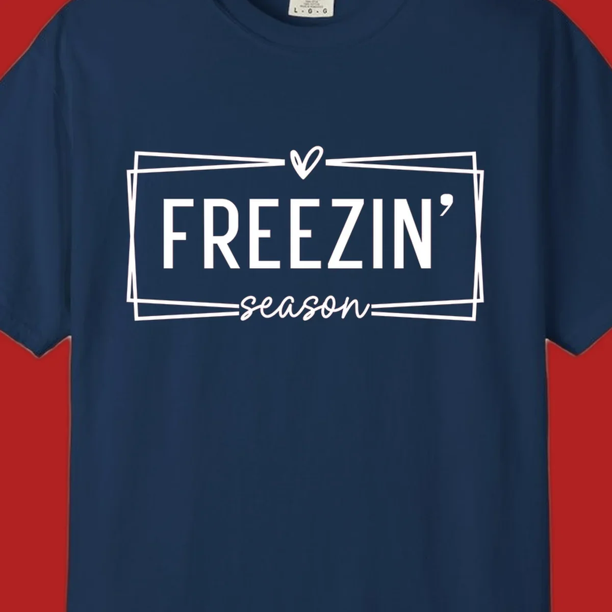Freezin' Season text design with heart icon and border, for winter holidays.